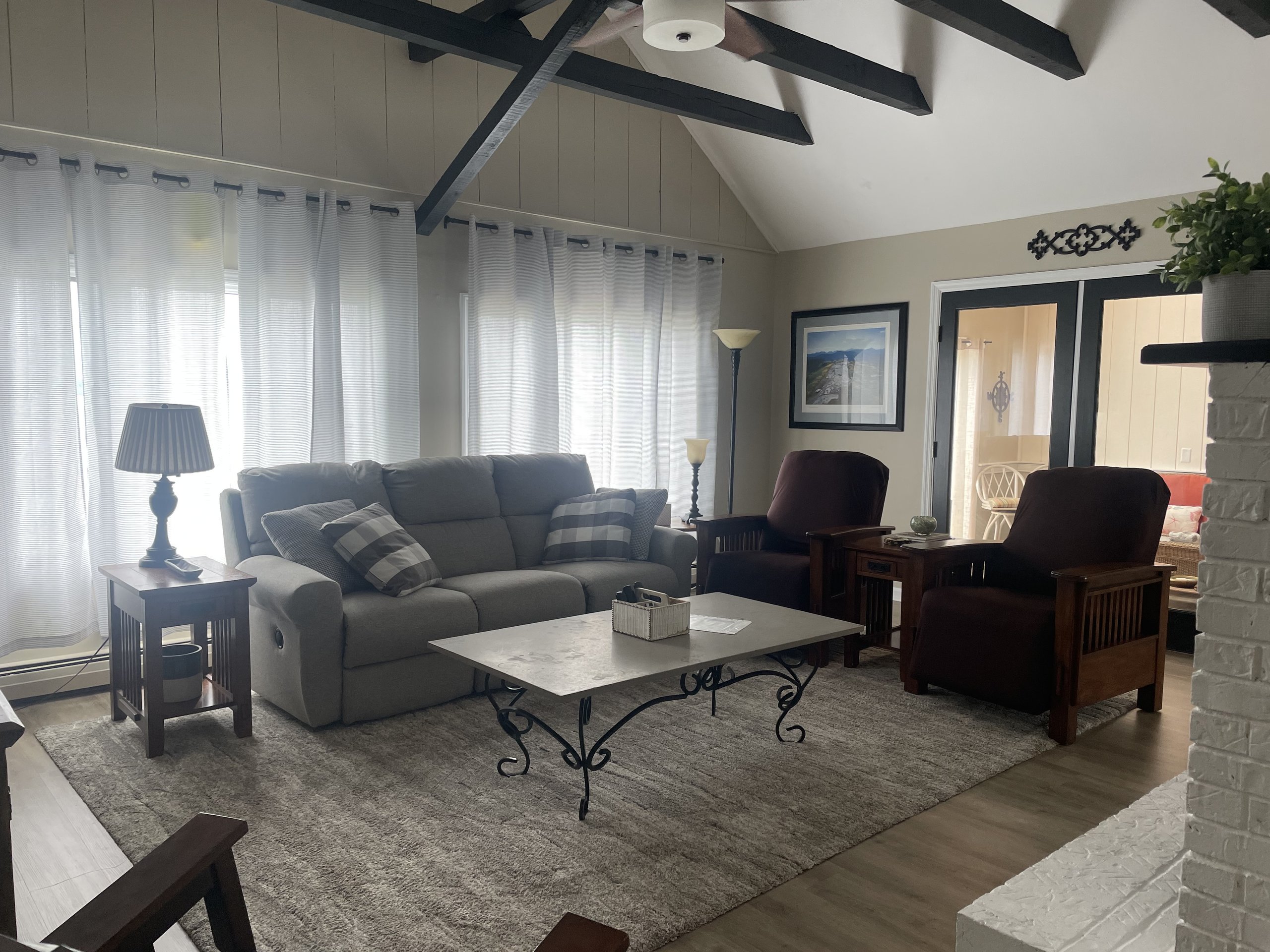 Living room opens through French doors to the screened lake porch