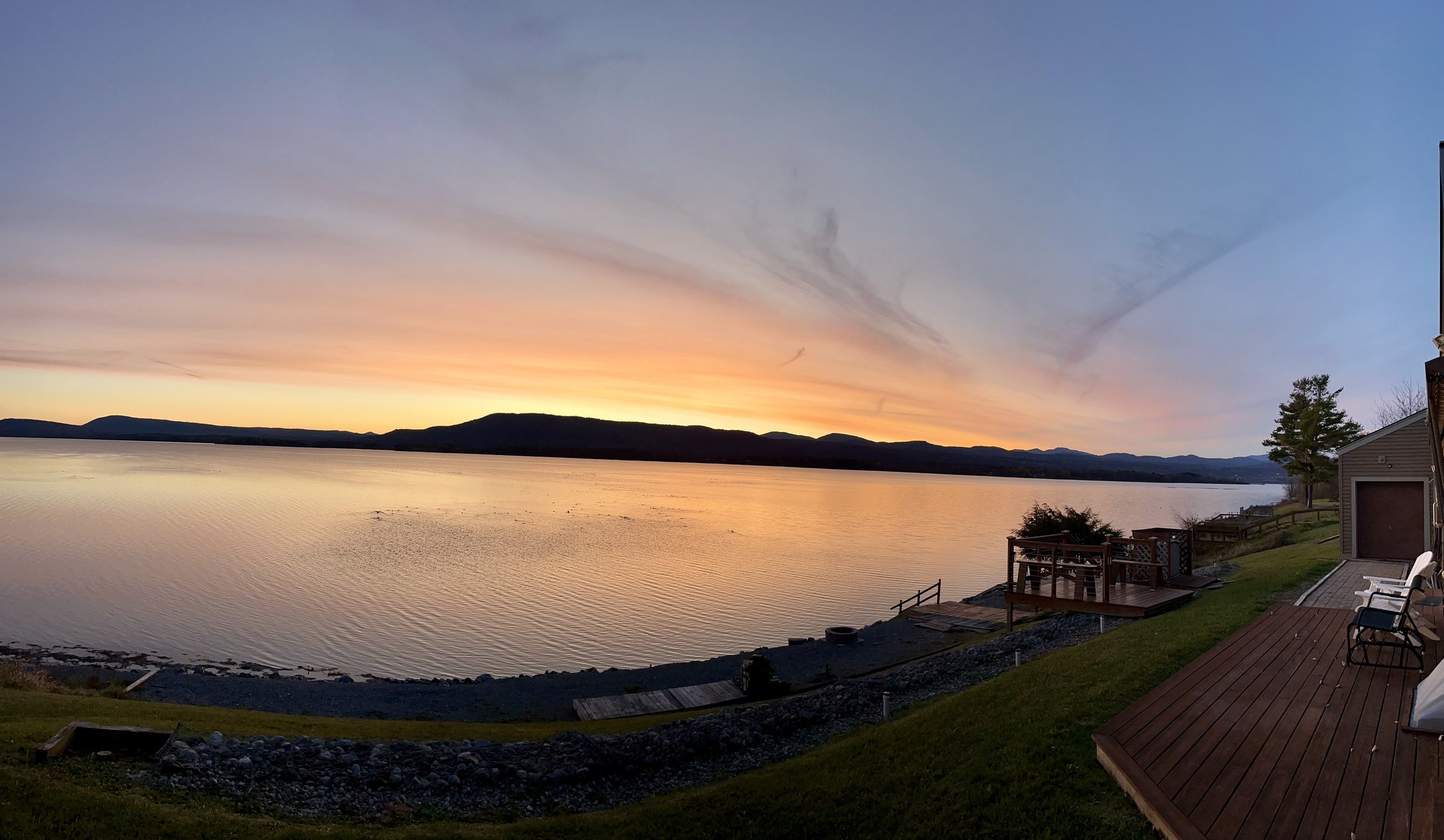 Panoramic sunset view from the deck overlooking the shoreline and Adirondack foothills