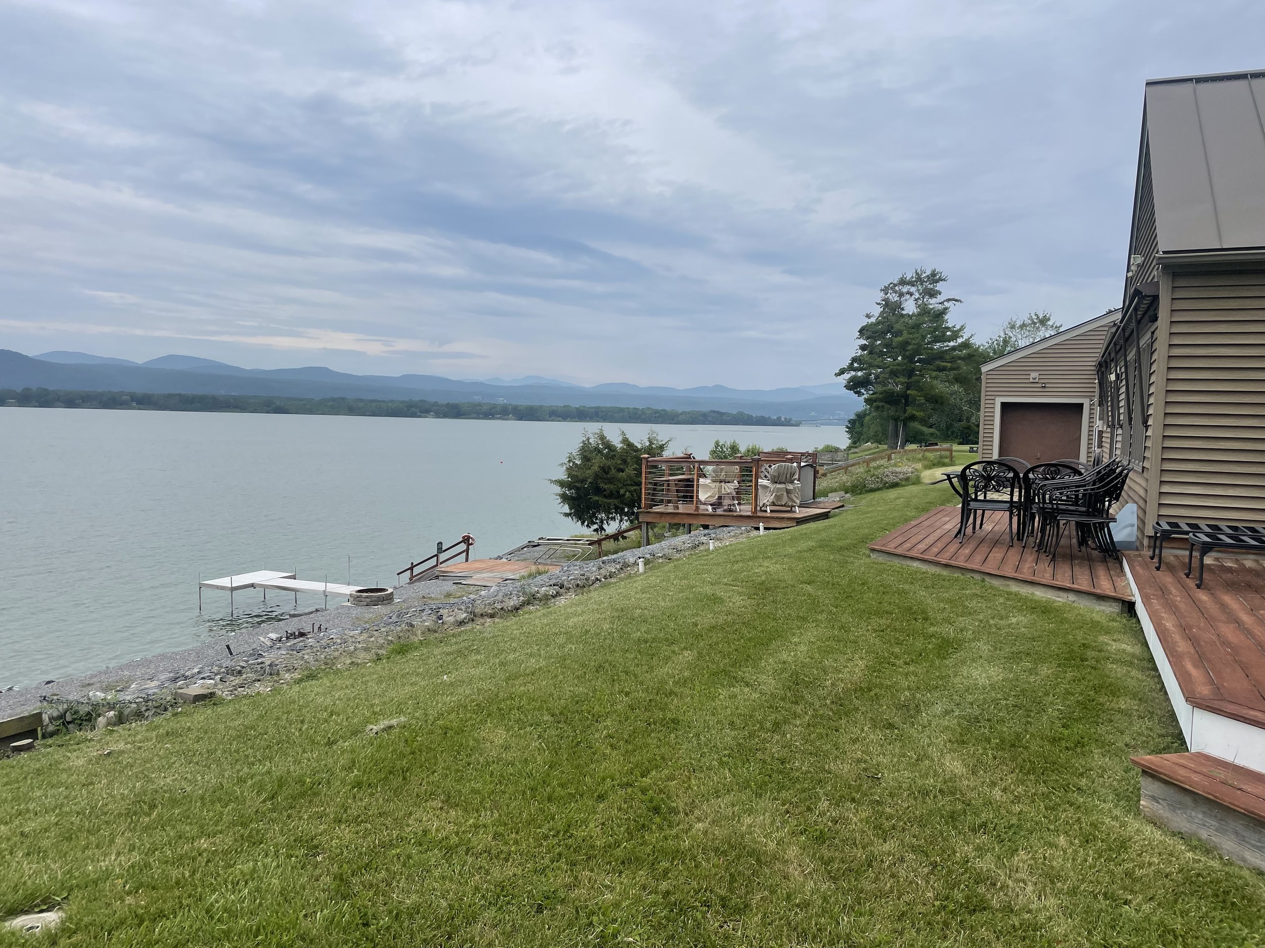 The backyard slopes down to a private dock and lake beyond