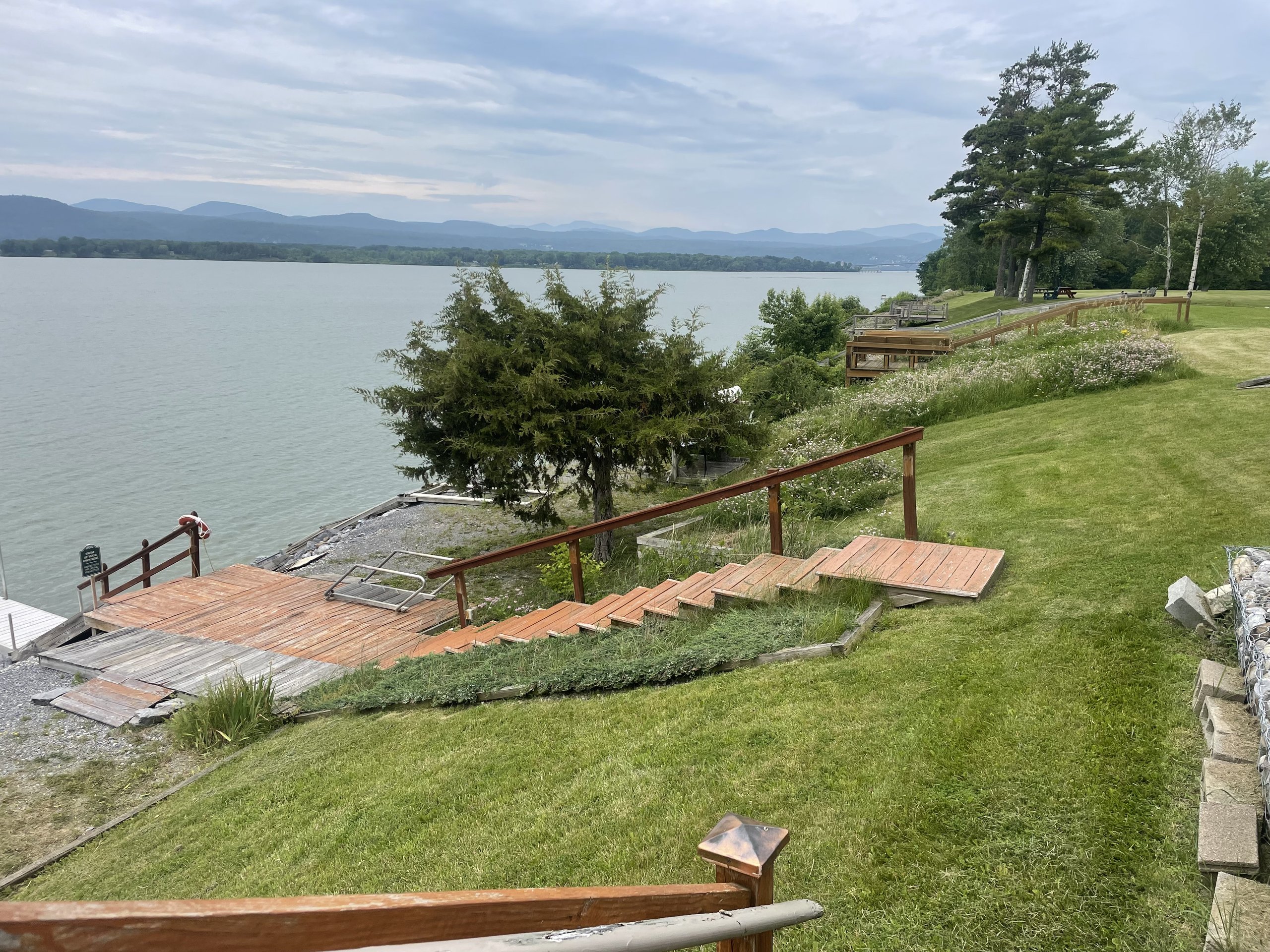 The lake house deck and stairway lead down toward the water's edge