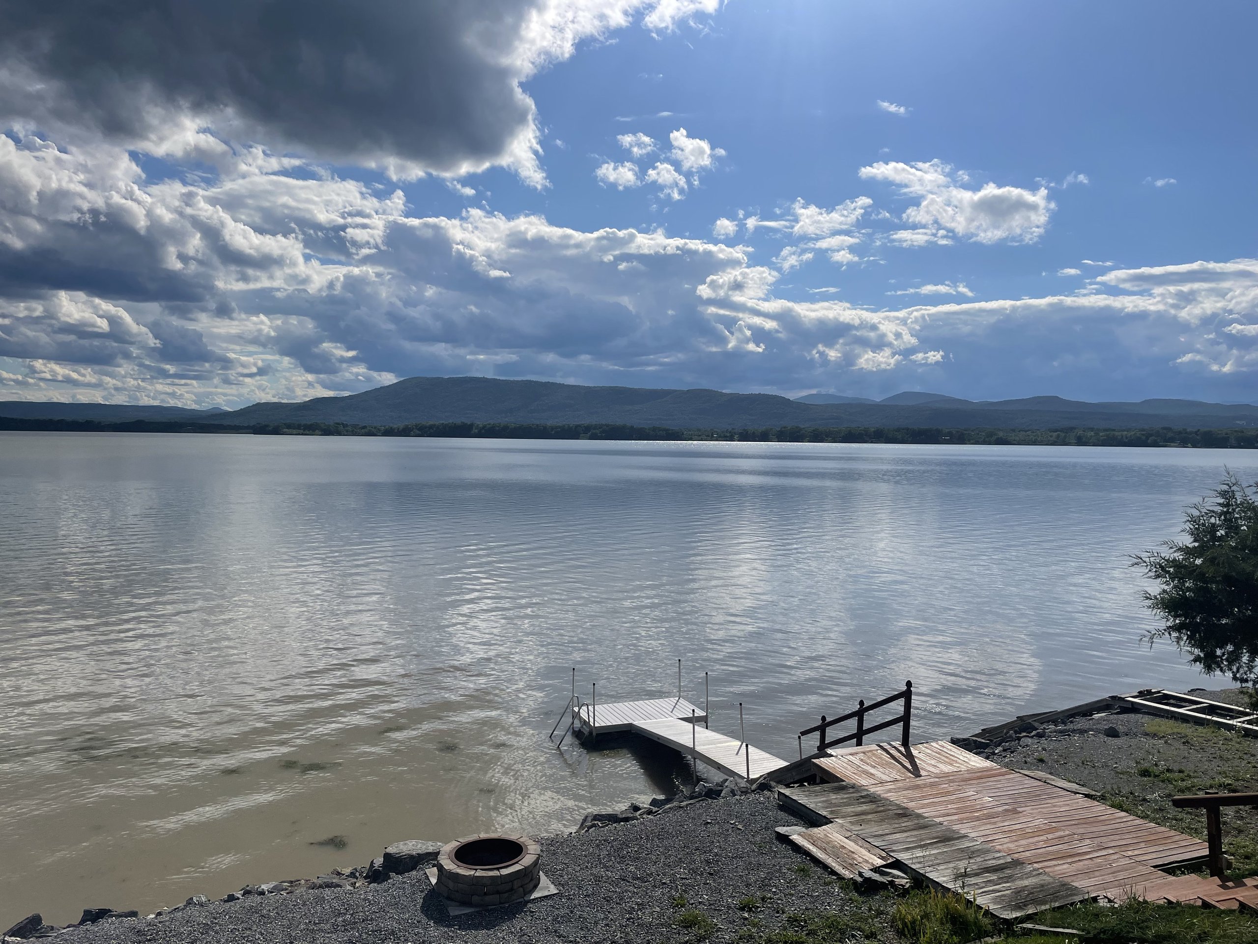 Blue skies and scattered clouds over the calm lake on a clear day