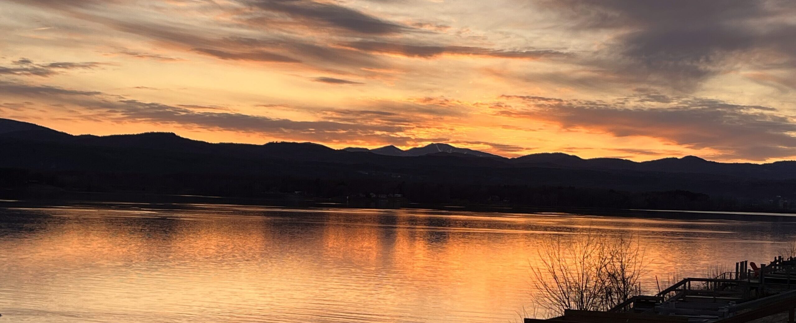 Sunset over Lake Champlain with the Adirondacks in silhouette, seen from the dock
